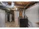 View of the utility area, featuring water heater, washer and dryer hookups, and concrete walls at 833 Osceola St, Denver, CO 80204