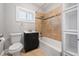 Cozy bathroom features a tub and shower combo, a black vanity, and tile flooring at 833 Osceola St, Denver, CO 80204