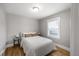 Neutral bedroom with a bed, side tables, and hardwood floors at 833 Osceola St, Denver, CO 80204
