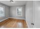 Empty bedroom featuring hardwood flooring, neutral paint, and a large window at 833 Osceola St, Denver, CO 80204