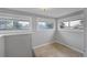 Bright bonus room with wainscoting, tile floor, and 3 windows at 833 Osceola St, Denver, CO 80204