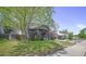 A charming home with a well-kept lawn and mature trees at 833 Osceola St, Denver, CO 80204