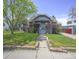 Quaint single story home featuring a lush green lawn at 833 Osceola St, Denver, CO 80204