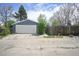 View of the detached two car garage with white garage door and access to the backyard at 833 Osceola St, Denver, CO 80204
