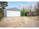 View of the detached two car garage with white garage door and access to the backyard at 833 Osceola St, Denver, CO 80204