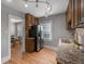 Traditional kitchen featuring stainless steel appliances, granite countertops, and hardwood flooring at 833 Osceola St, Denver, CO 80204