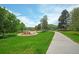 Picturesque park view with lush lawns, playground, and paved walkways at 833 Osceola St, Denver, CO 80204