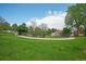 Community pool in a fenced area surrounded by a grassy area with a walking path at 833 Osceola St, Denver, CO 80204