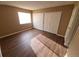 Bedroom with hardwood floors, a window for natural light, and a closet with sliding doors at 18051 E Kentucky Ave # 201, Aurora, CO 80017