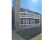 Gray apartment building with balconies and a stone accent wall near the stairwell at 18051 E Kentucky Ave # 201, Aurora, CO 80017