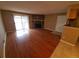 Bright living room featuring a stone fireplace, sliding glass doors, and hardwood flooring at 18051 E Kentucky Ave # 201, Aurora, CO 80017