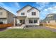Back of a two-story home with a porch and a grassy yard area at 10912 Memphis Ct, Commerce City, CO 80022
