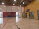 Spacious indoor basketball court with hardwood floors, modern lighting, and a high ceiling at 10912 Memphis Ct, Commerce City, CO 80022