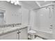 Bathroom featuring a granite countertop vanity and a shower-tub combo at 10912 Memphis Ct, Commerce City, CO 80022
