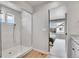 A sleek glass shower is showcased, with a glimpse into the connected bedroom at 10912 Memphis Ct, Commerce City, CO 80022