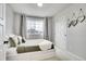 Cozy bedroom with a comfortable bed, natural light, and closet with sliding doors at 10912 Memphis Ct, Commerce City, CO 80022