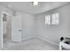 Bedroom with neutral carpet, paint, and trim with two windows offering views at 10912 Memphis Ct, Commerce City, CO 80022