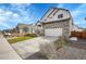 Charming home featuring a well-manicured lawn, stone accents and a long driveway at 10912 Memphis Ct, Commerce City, CO 80022