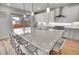 Modern kitchen boasts granite countertops, stainless steel appliances, and seating at the island at 10912 Memphis Ct, Commerce City, CO 80022