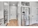 Well-lit kitchen with stainless steel refrigerator and appliances, complemented by light hardwood floors at 10912 Memphis Ct, Commerce City, CO 80022
