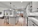 Spacious kitchen and living area with hardwood floors, granite counters, and modern appliances at 10912 Memphis Ct, Commerce City, CO 80022