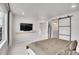 Main bedroom with a television and sliding barn door to the bathroom at 10912 Memphis Ct, Commerce City, CO 80022