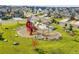 Aerial view of community playground including slides, swings, benches and a covered gazebo at 10912 Memphis Ct, Commerce City, CO 80022