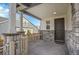 Inviting front porch with stone columns and charming entrance at 10912 Memphis Ct, Commerce City, CO 80022