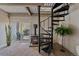 Cozy living room features a spiral staircase, and a charming fireplace with access to the outside patio at 80 Clear Creek Ln # 10, Golden, CO 80403