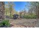 Outdoor patio features a grill, dining table, stone border, and lush foliage at 80 Clear Creek Ln # 10, Golden, CO 80403