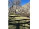 River view shows trees hanging over river and green grass area at 80 Clear Creek Ln # 10, Golden, CO 80403