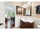 Bathroom featuring a stylish vanity with dark wood cabinets and decorative lighting at 1331 Osceola St, Denver, CO 80204