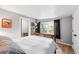 Bedroom featuring natural light from the window, hardwood floors, and access to an adjacent room at 1331 Osceola St, Denver, CO 80204
