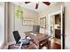 Well-lit home office with a large monitor, comfortable chair, and decorative wall art at 1331 Osceola St, Denver, CO 80204