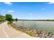 Scenic lake view with a paved path and lush greenery, perfect for outdoor recreation at 1331 Osceola St, Denver, CO 80204