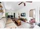 Bright living room with hardwood floors, a ceiling fan, and access to the dining area, creating a comfortable space at 1331 Osceola St, Denver, CO 80204