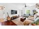 Cozy living room with a mounted TV, a guitar, and comfortable couches at 1331 Osceola St, Denver, CO 80204