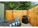 Inviting patio area featuring a grill, string lights, wood fence, table and comfortable chairs at 1331 Osceola St, Denver, CO 80204