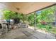 Covered patio with seating and a view of the lush backyard and surrounding greenery at 2516 S Cimarron St, Aurora, CO 80014