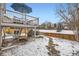 Backyard featuring a deck, table and chairs, and stairs down to a stone walking path at 6366 Nassau Ct, Highlands Ranch, CO 80130