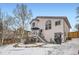 Exterior backyard featuring a deck, stairs, grill, storage, and snow-covered yard at 6366 Nassau Ct, Highlands Ranch, CO 80130