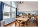 Spacious dining room with large windows and hardwood floors next to the cozy living room at 6366 Nassau Ct, Highlands Ranch, CO 80130