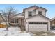 Exterior of a two-story home featuring an attached garage and covered front patio at 6366 Nassau Ct, Highlands Ranch, CO 80130