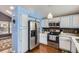 Well-appointed kitchen featuring white cabinets, stainless steel appliances, and granite countertops at 6366 Nassau Ct, Highlands Ranch, CO 80130