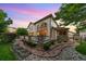 Expansive backyard featuring stone walkway, lush lawn, and architectural home at 6427 S Tibet St, Aurora, CO 80016