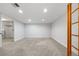 Large unfinished basement with carpeted floors and good lighting, ready to be customized at 6427 S Tibet St, Aurora, CO 80016