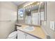 Bright bathroom featuring a vanity with sink and a large mirror and bright lighting at 6427 S Tibet St, Aurora, CO 80016
