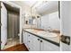 Functional bathroom with double sinks, large mirrors and a shower/tub combo at 6427 S Tibet St, Aurora, CO 80016