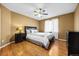 Cozy bedroom with wood floors, ceiling fan, and neutral paint at 6427 S Tibet St, Aurora, CO 80016
