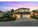 Beautiful two-story home featuring a stone facade, spacious garage, manicured lawn, and beautiful landscaping at 6427 S Tibet St, Aurora, CO 80016